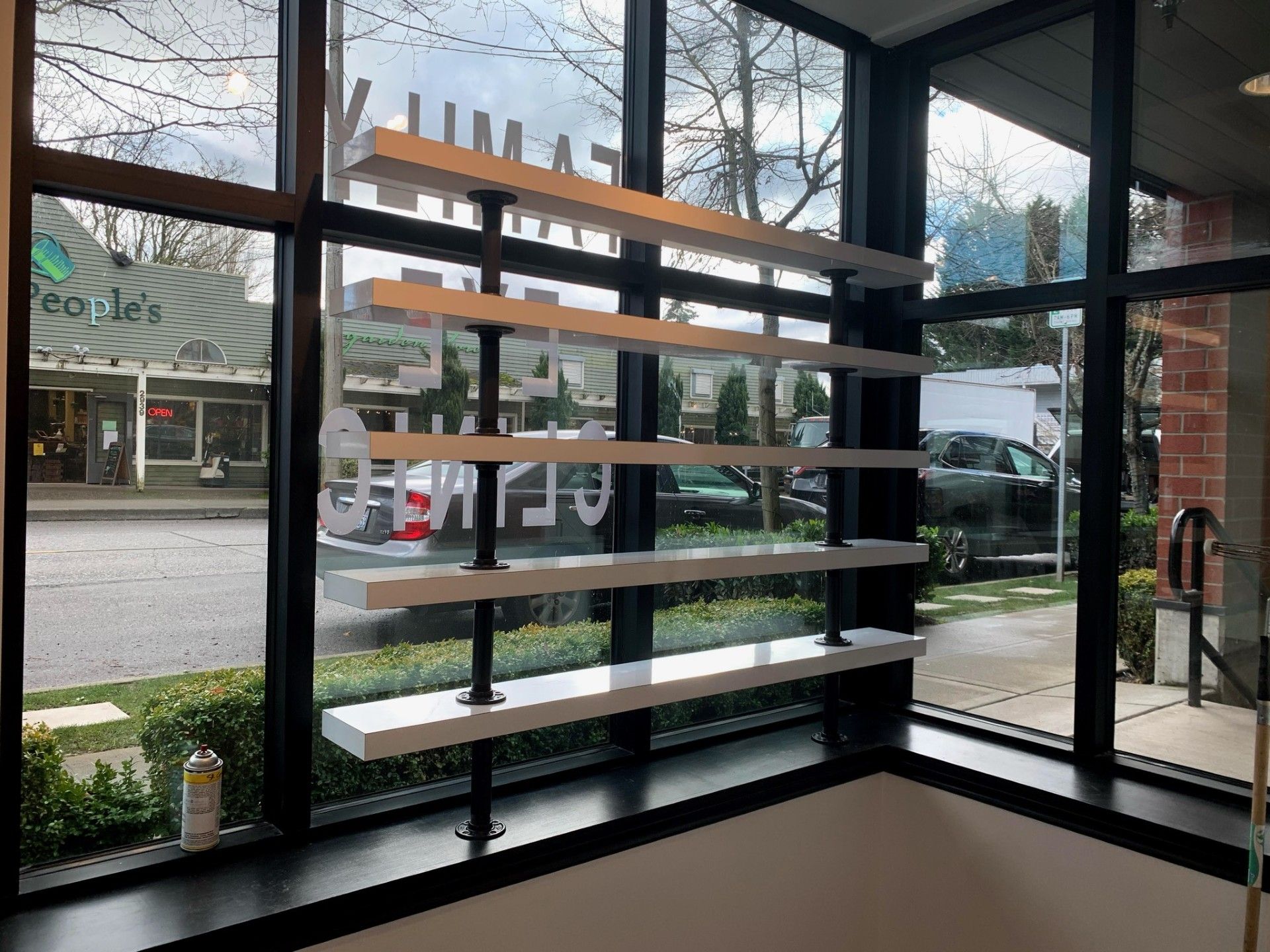 A large window with a shelf in front of it.