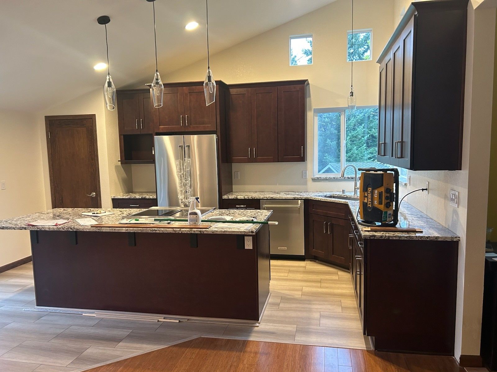 A kitchen with stainless steel appliances and wooden cabinets.