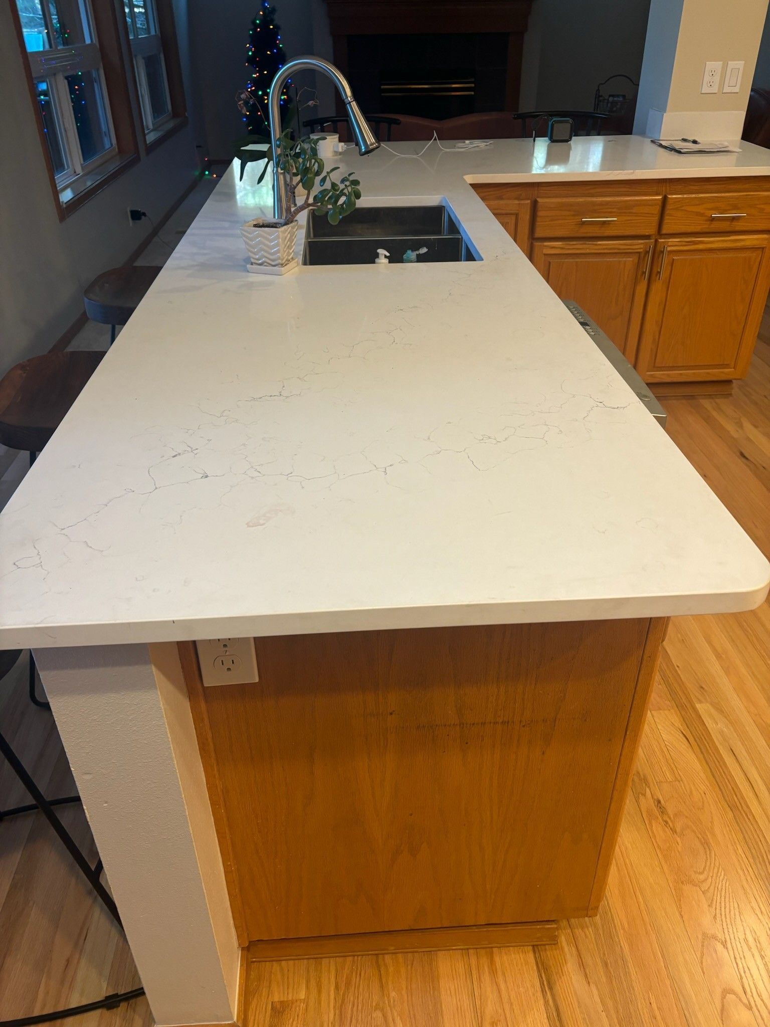 A kitchen with a large white counter top and a sink.