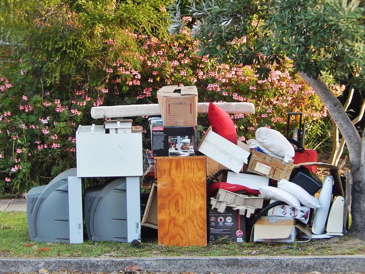 A pile of junk is sitting on the side of the road