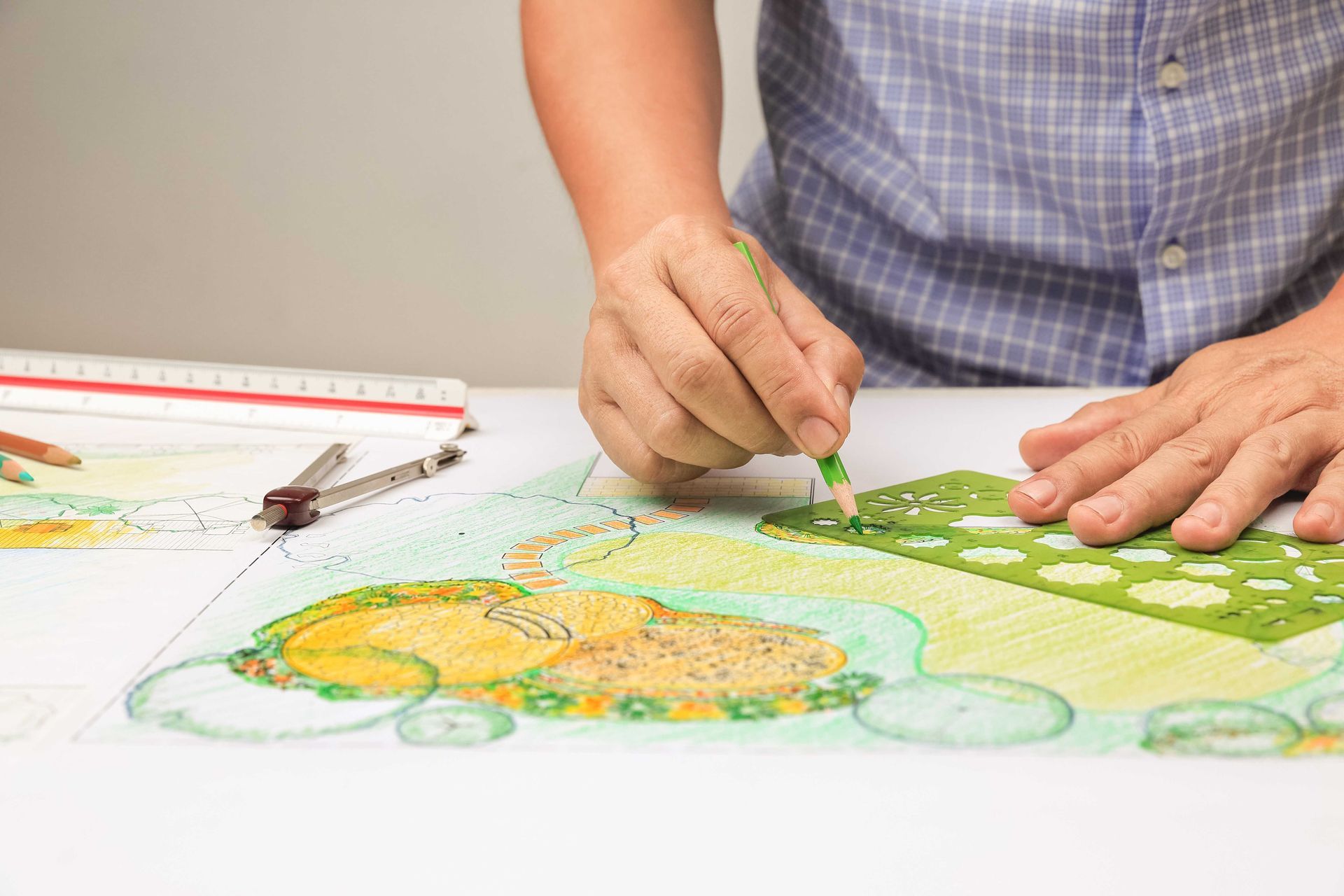 landscape architect draws out stone patio plans