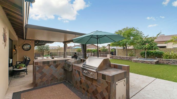 home patio with outdoor kitchen and landscape design