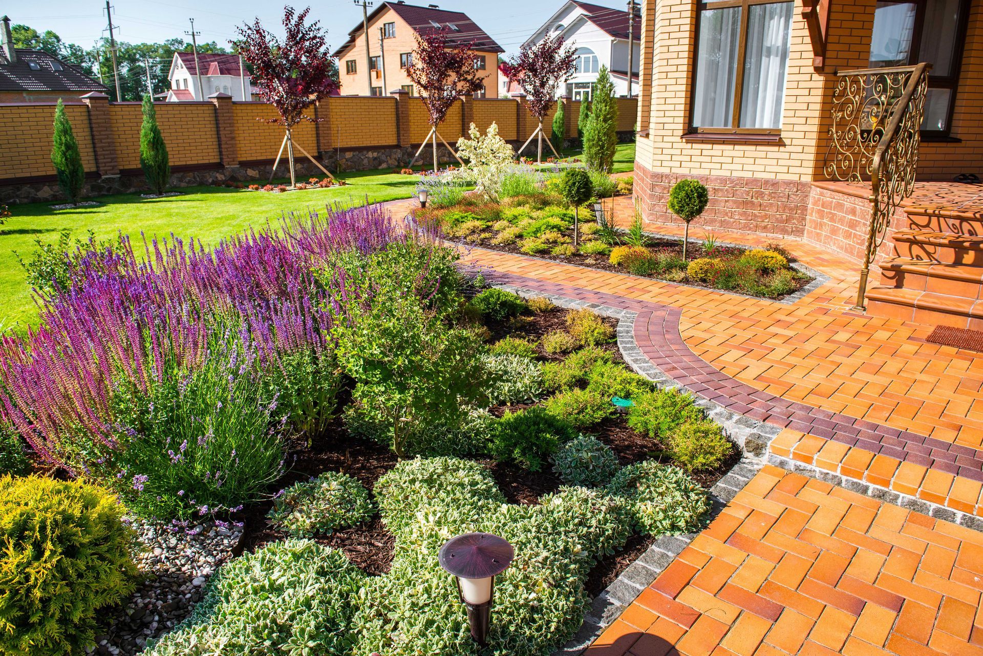 brick pathyway in landscaped yard with plants