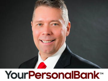 Headshot of a smiling banker in a black suit and red tie with YourPersonalBank logo
