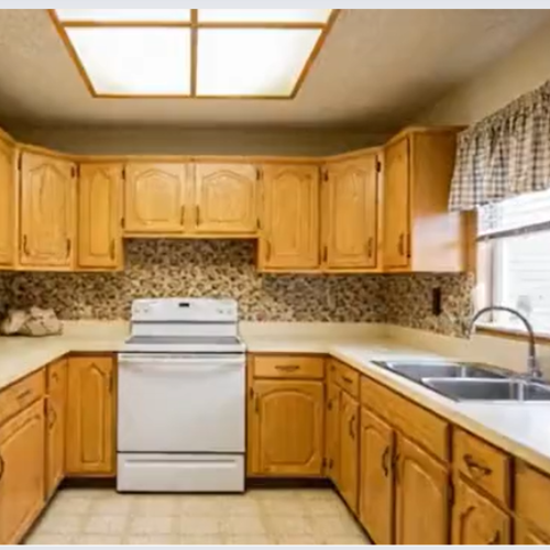 Before photo of a dated wooden kitchen in Kent with brown cabinets and tiled backsplash, before renovation by a Medway builder.