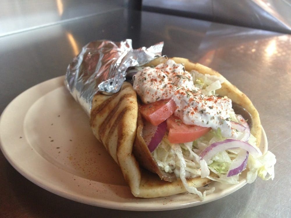 A close up of a gyro on a plate.