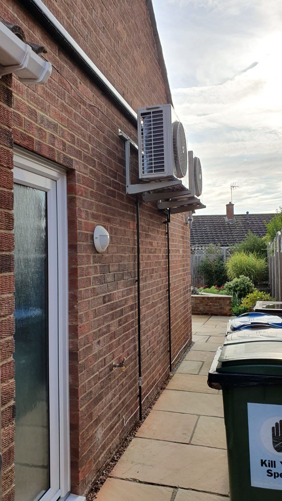 Two air intakes, wall mouthed on the outside of a domestic property.