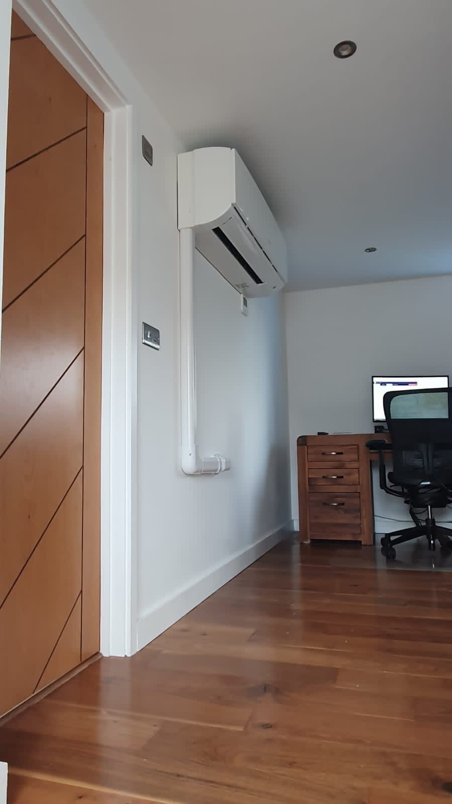 A white domestic air conditioning unit