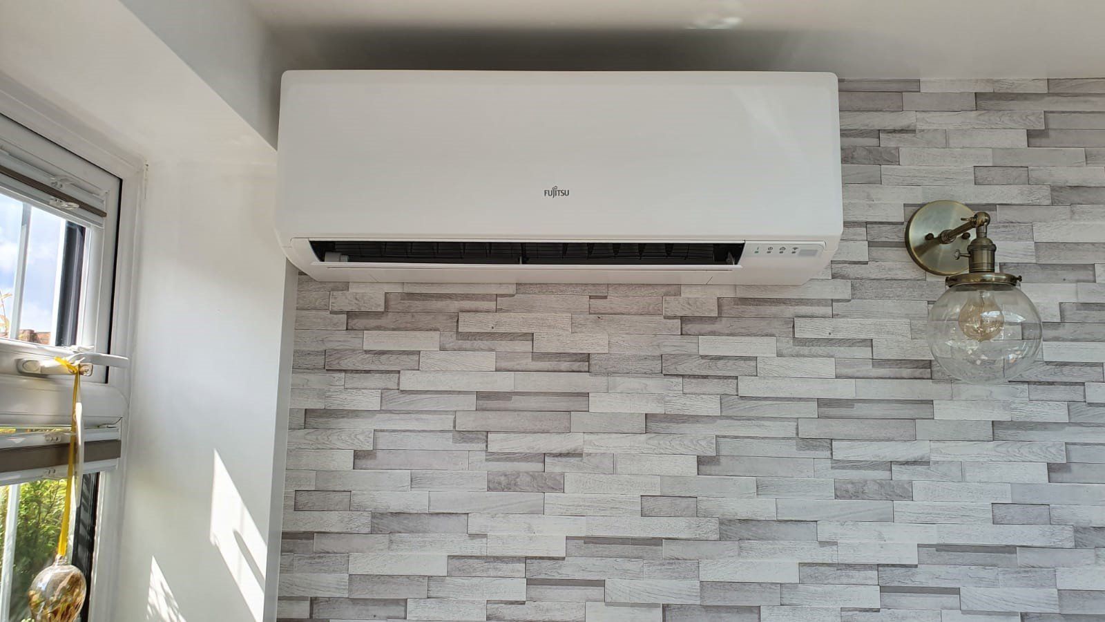 A white, wall-mounted AC unit.