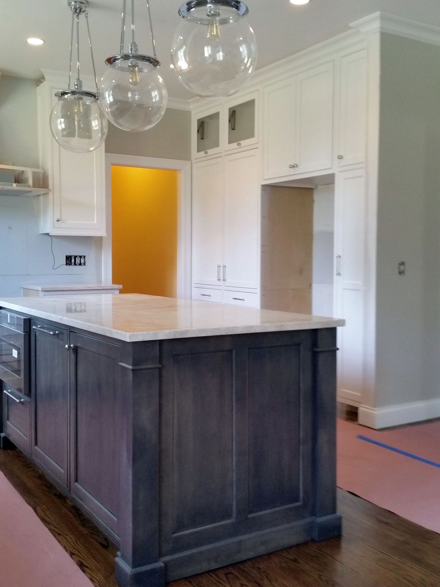 a kitchen with a large island and white cabinets