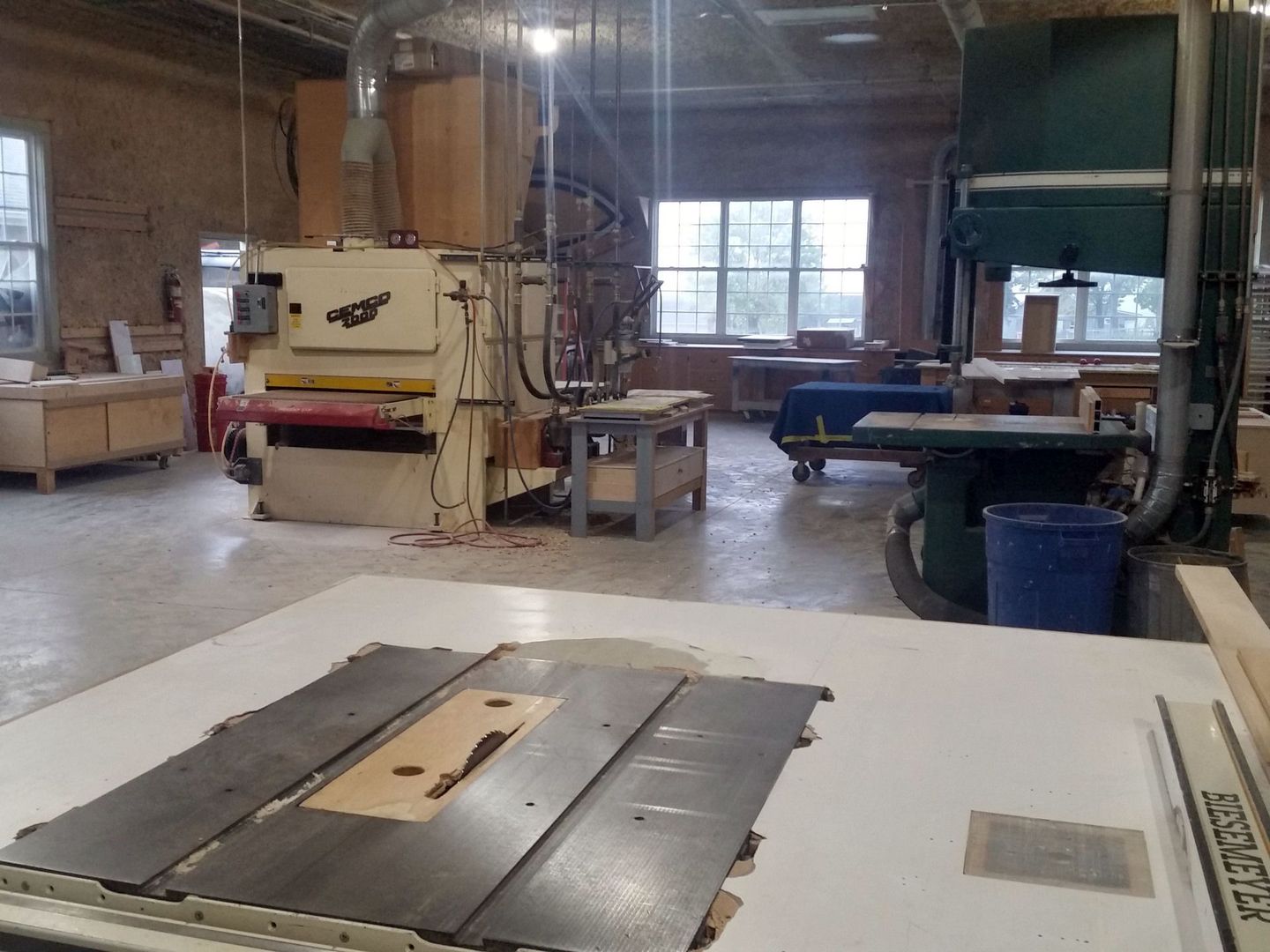 a woodworking shop with a table saw in the foreground