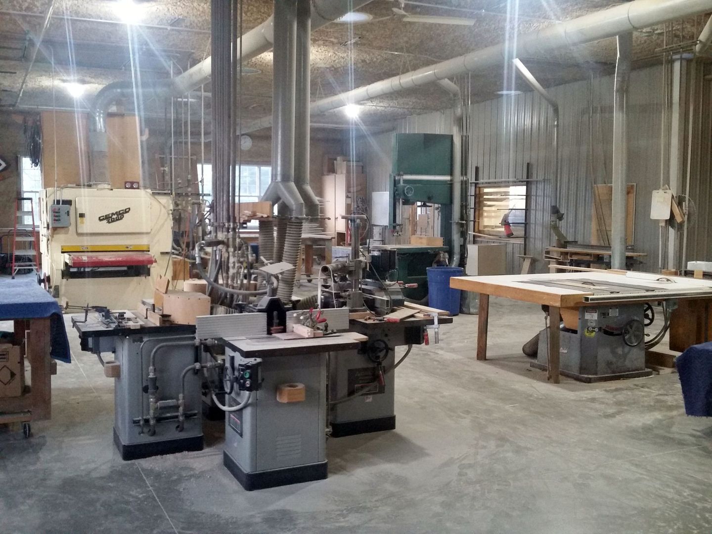 a large room filled with lots of machinery and tables.