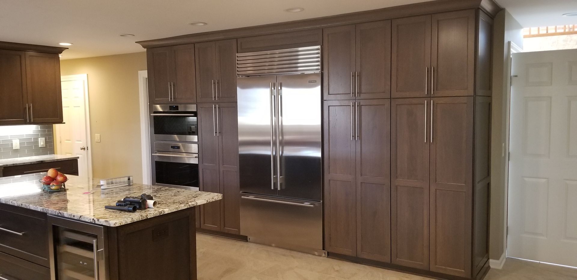 a kitchen with stainless steel appliances and white cabinets

