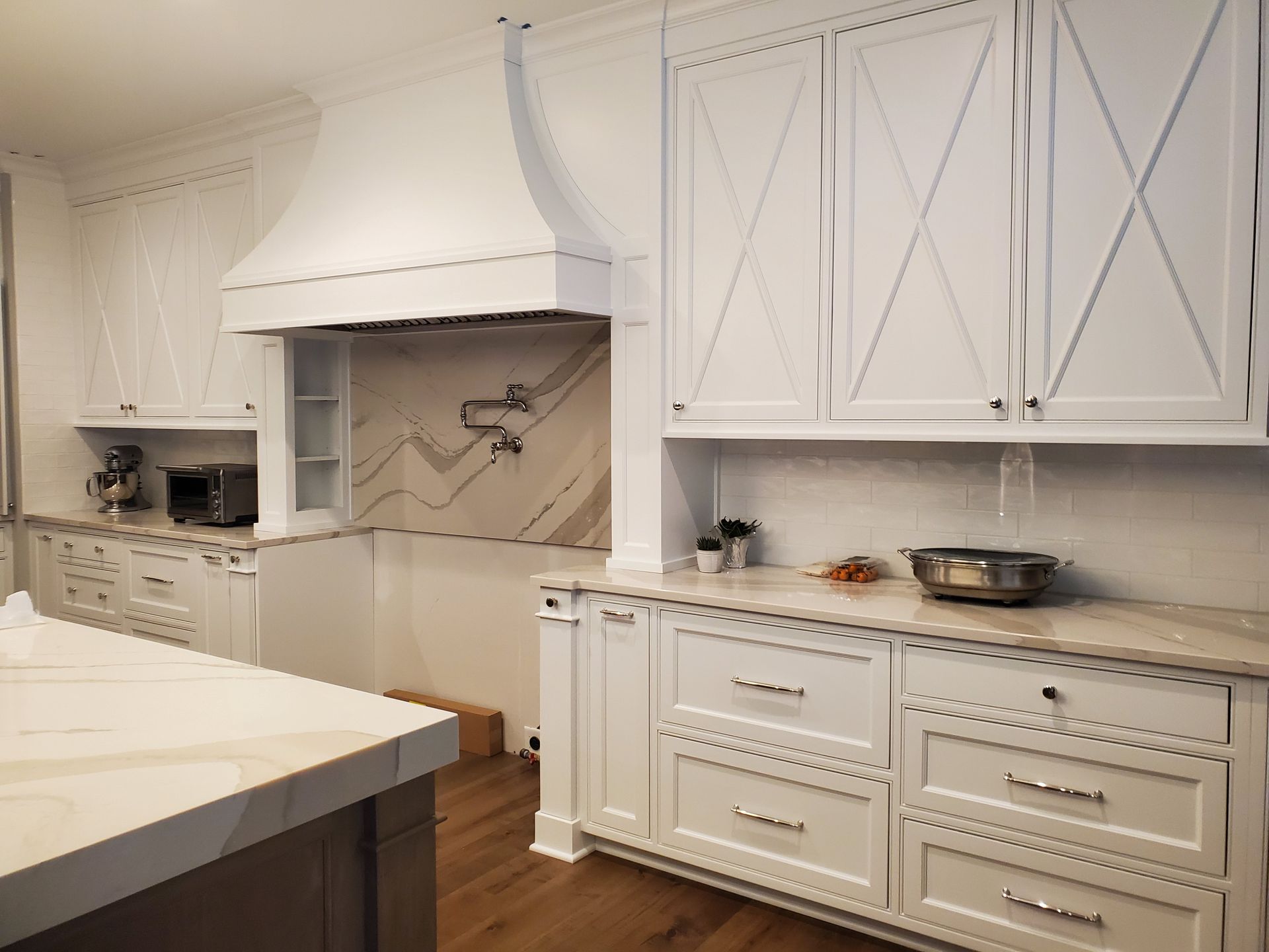 a kitchen with white cabinets and stainless steel appliances Amish Cabinets.