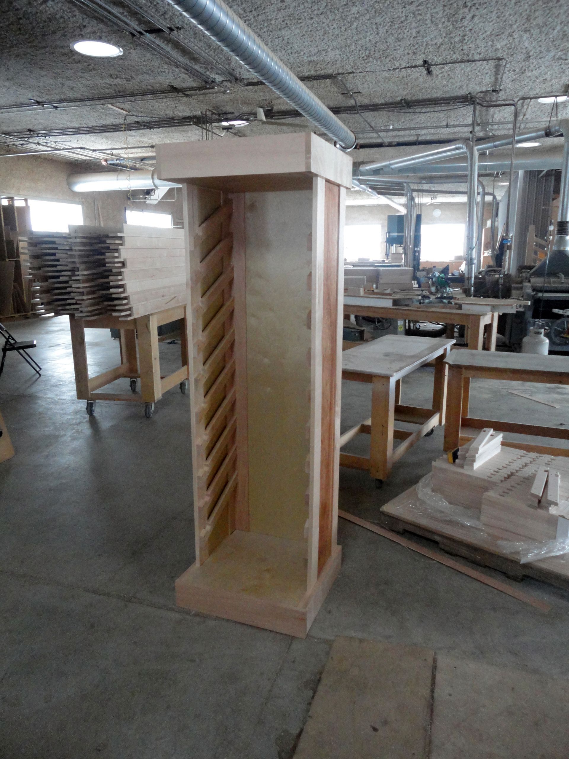 a wooden shelf is sitting in the middle of a warehouse