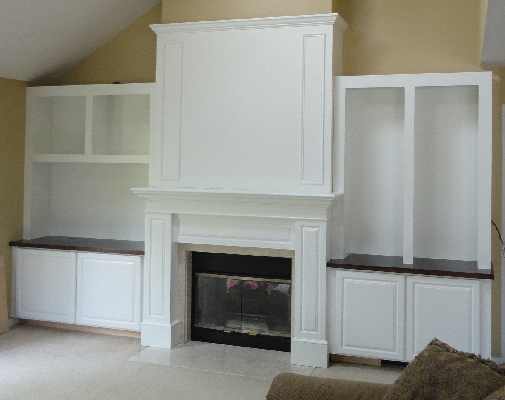 a wooden cabinet is sitting in a room next to a wall .