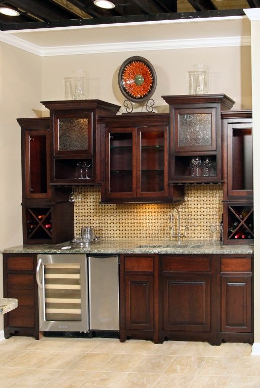a kitchen with wooden cabinets and a stainless steel refrigerator