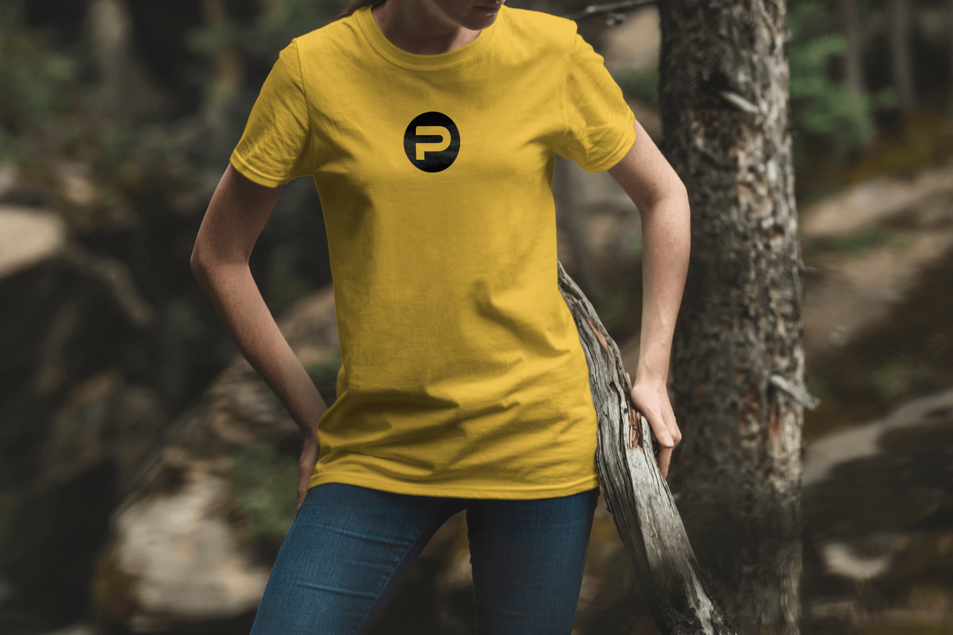 A woman wearing a yellow t-shirt with the letter p on it