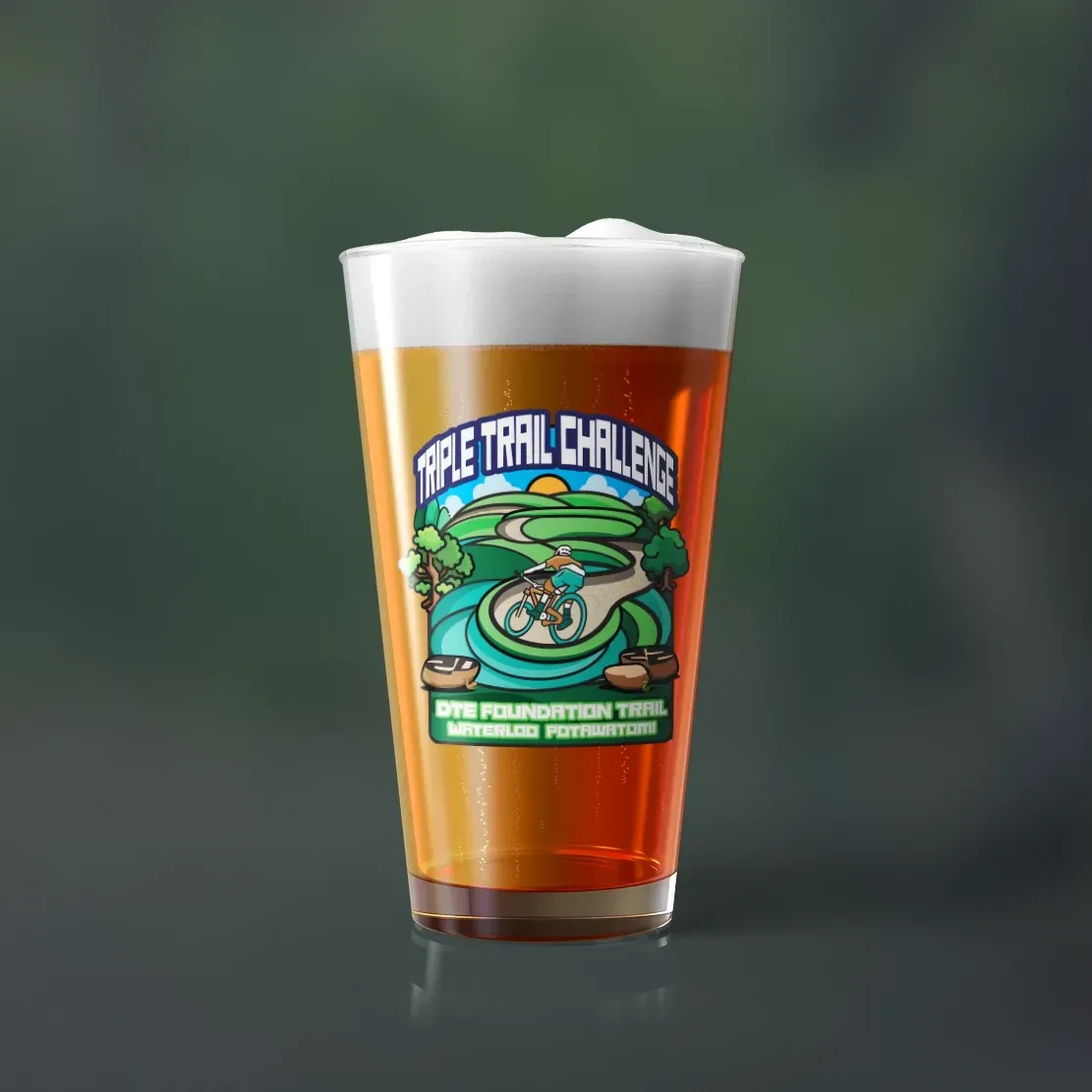 A glass of beer with a label that says free trail challenge