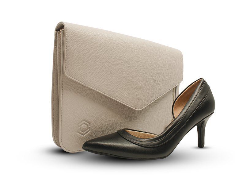 A pair of black shoes next to a white purse