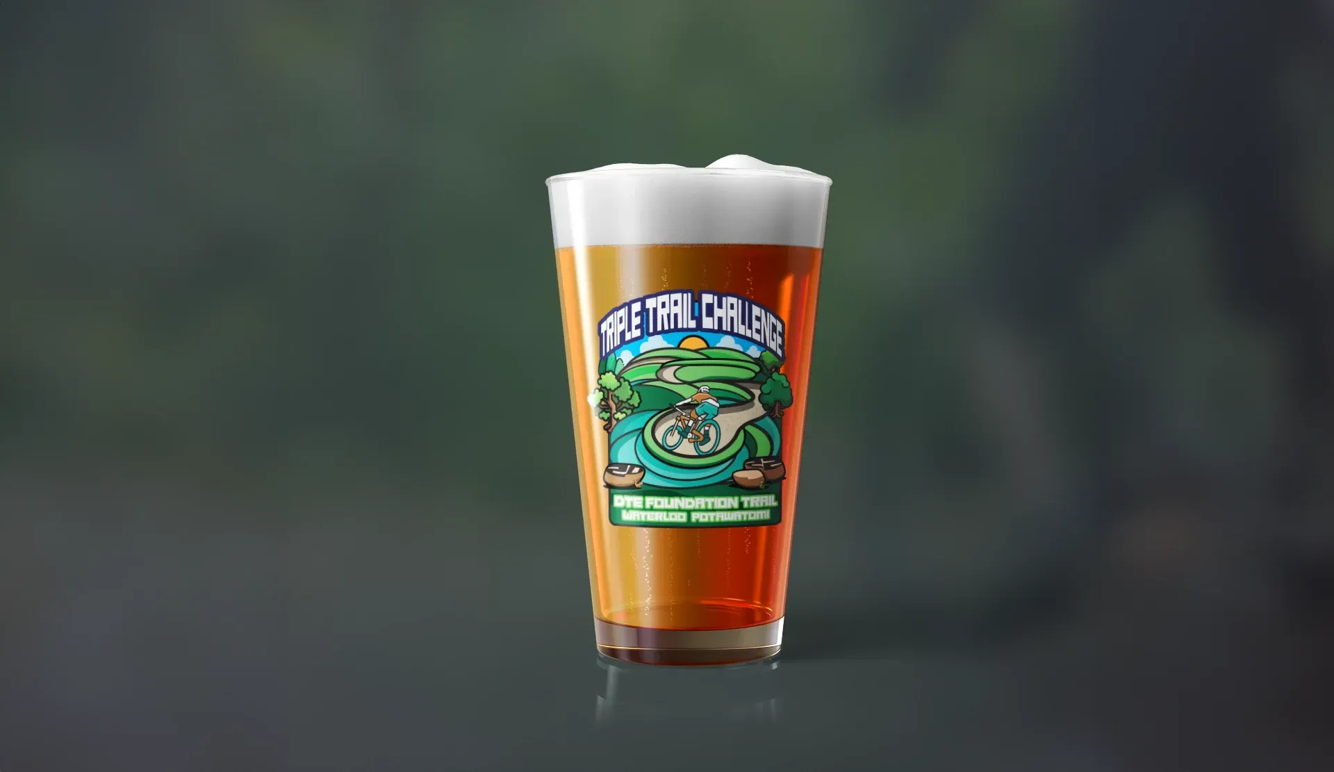 A glass of beer with a frog on it is sitting on a table.