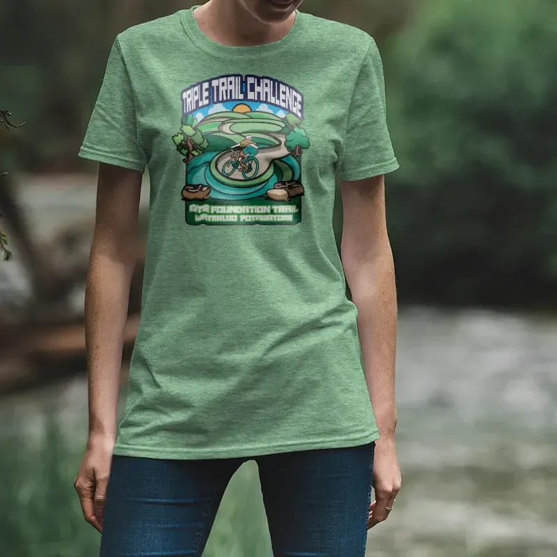 A woman wearing a green t-shirt that says the trail challenge