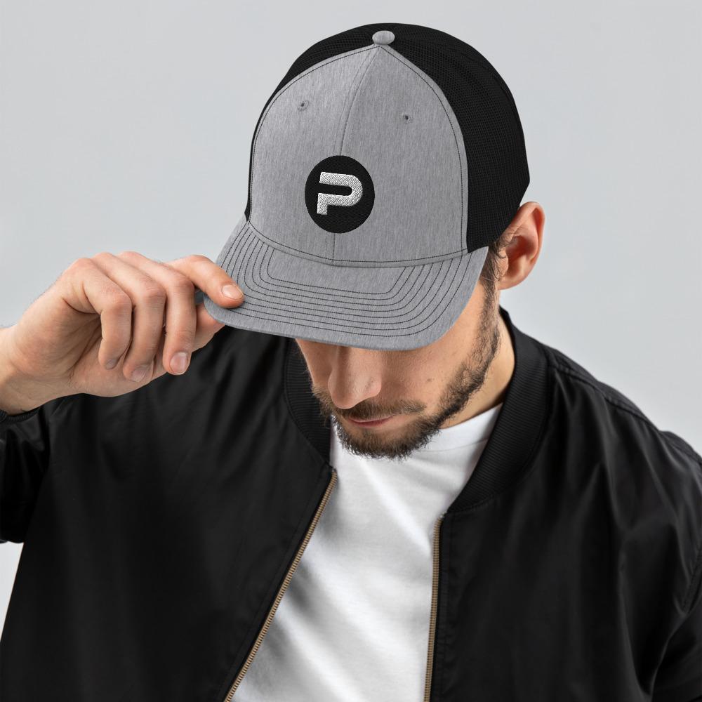 A man wearing a hat with the letter p on it