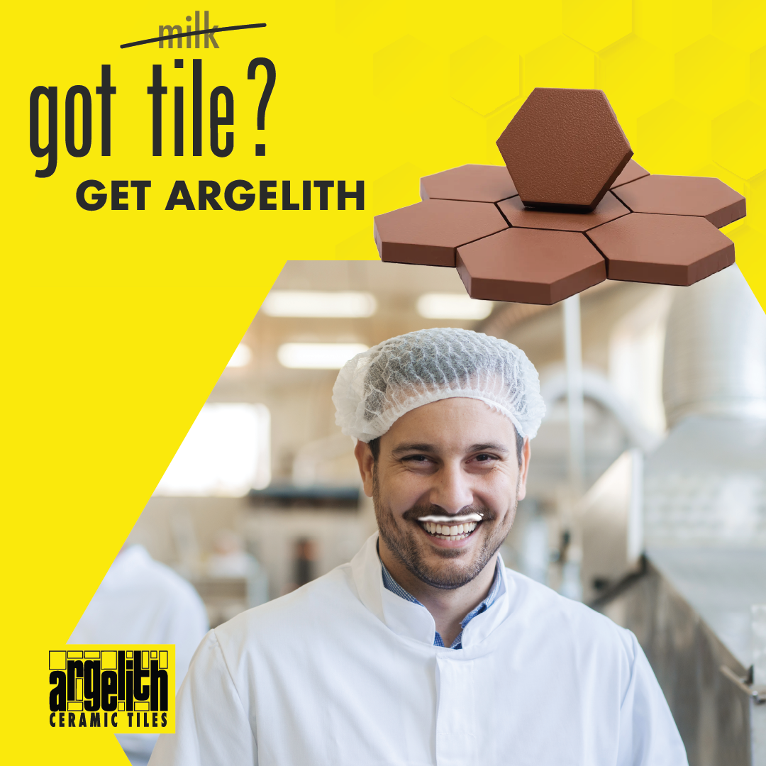 A smiling person with a white milk mustache wears a hairnet. Above them are red hexagonal tiles on a yellow background.