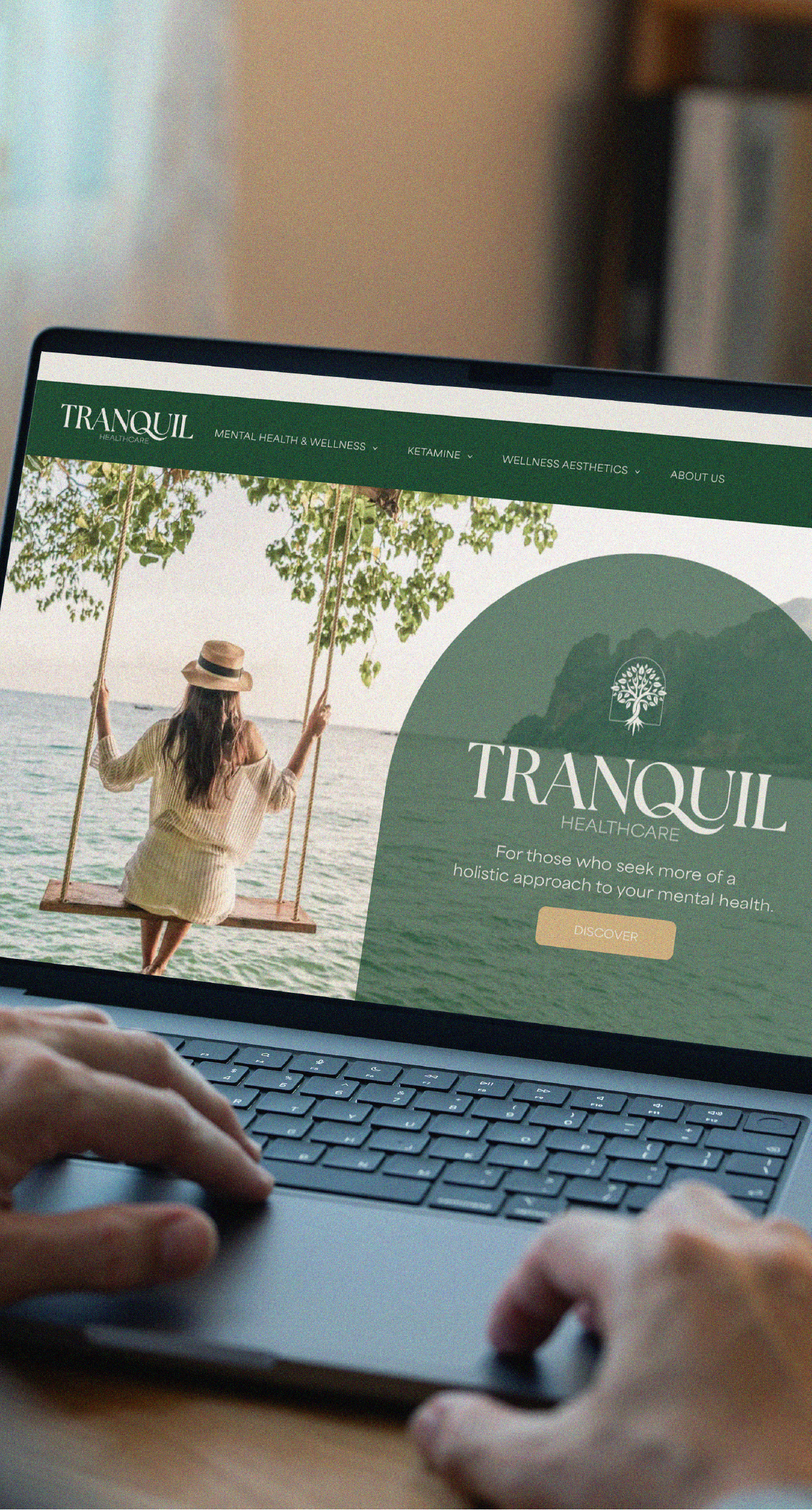 Hands typing on a laptop displaying a website titled 