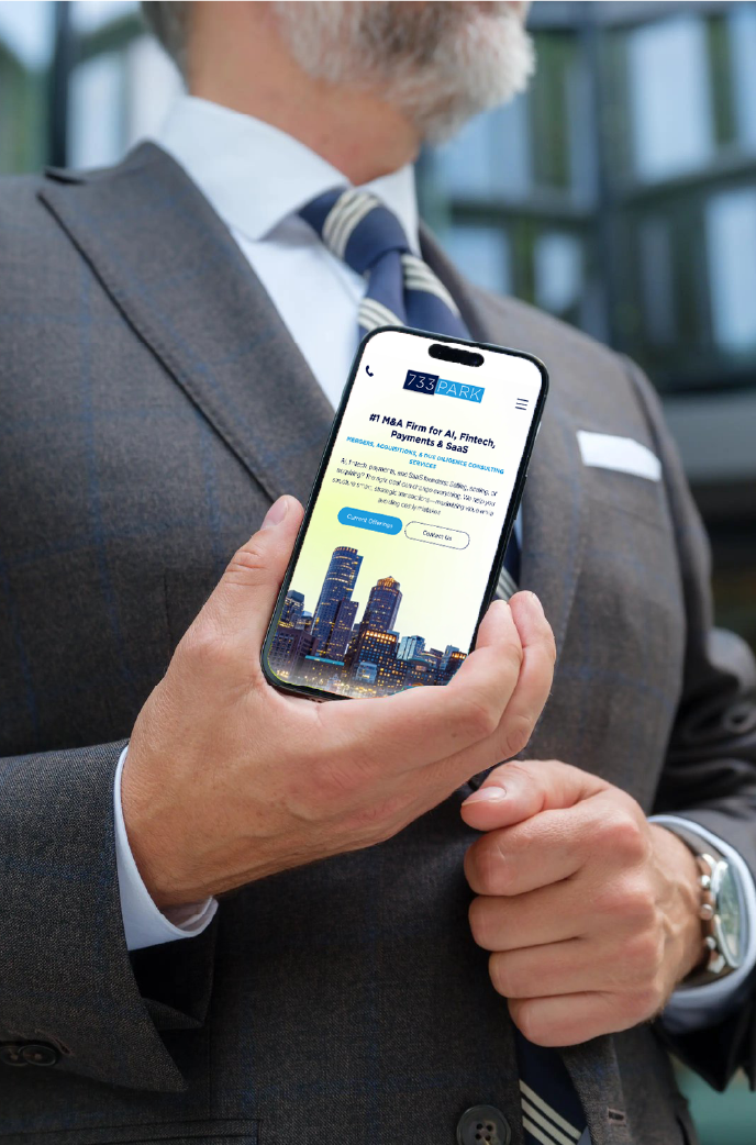 A person in a suit holds a smartphone displaying a website with a city skyline image and text about investment.