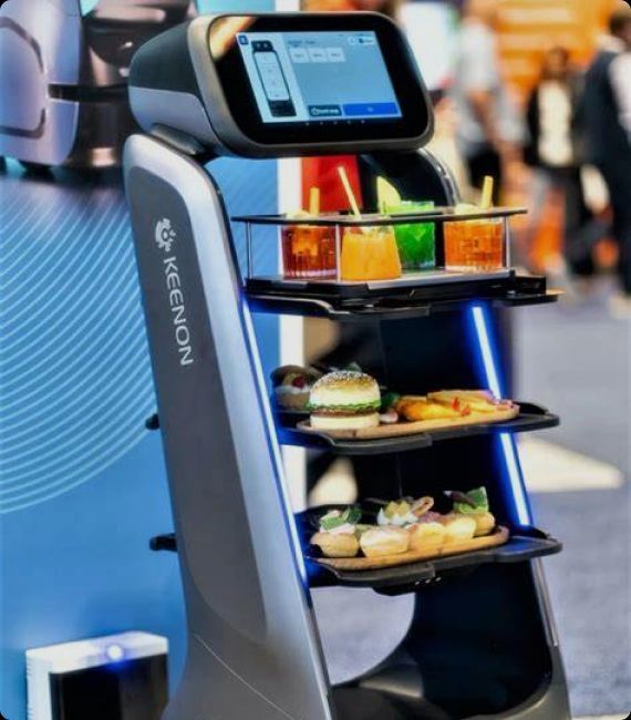 A food service robot with trays holding food and drinks. It is inside a restaurant.