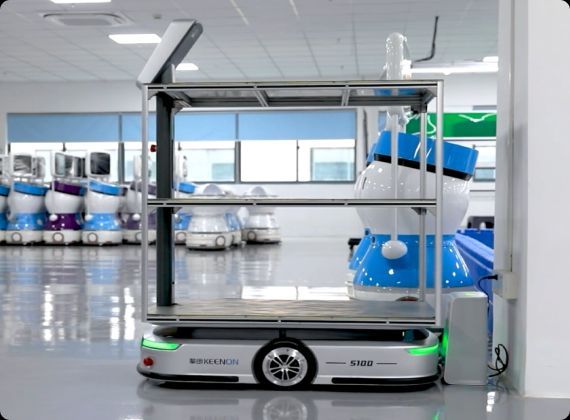 Automated guided vehicle with shelving; blue and white robot-like design, in a factory setting.