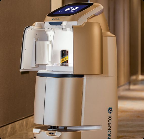 Robot delivering a small item from its compartment in a hotel hallway.