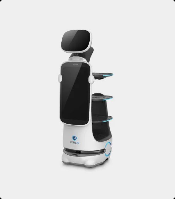 White service robot with a large screen, carrying shelves, in a bright setting.