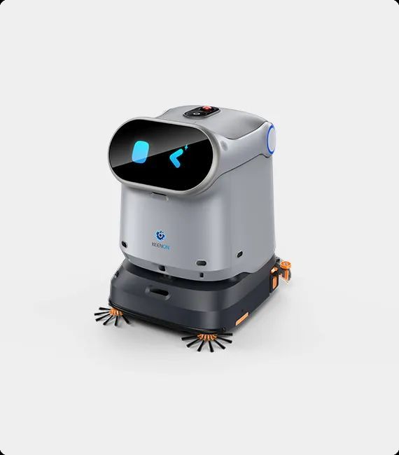 Robot cleaner, gray and black, with a screen displaying a smiling face. Has cleaning brushes, on a white background.