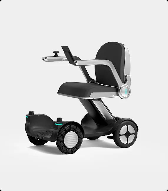 Black and silver motorized wheelchair with small wheels, armrest, and a seat.
