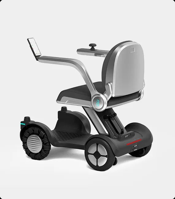 Self-balancing mobility device with a silver seat and black base. It has a touchscreen armrest.