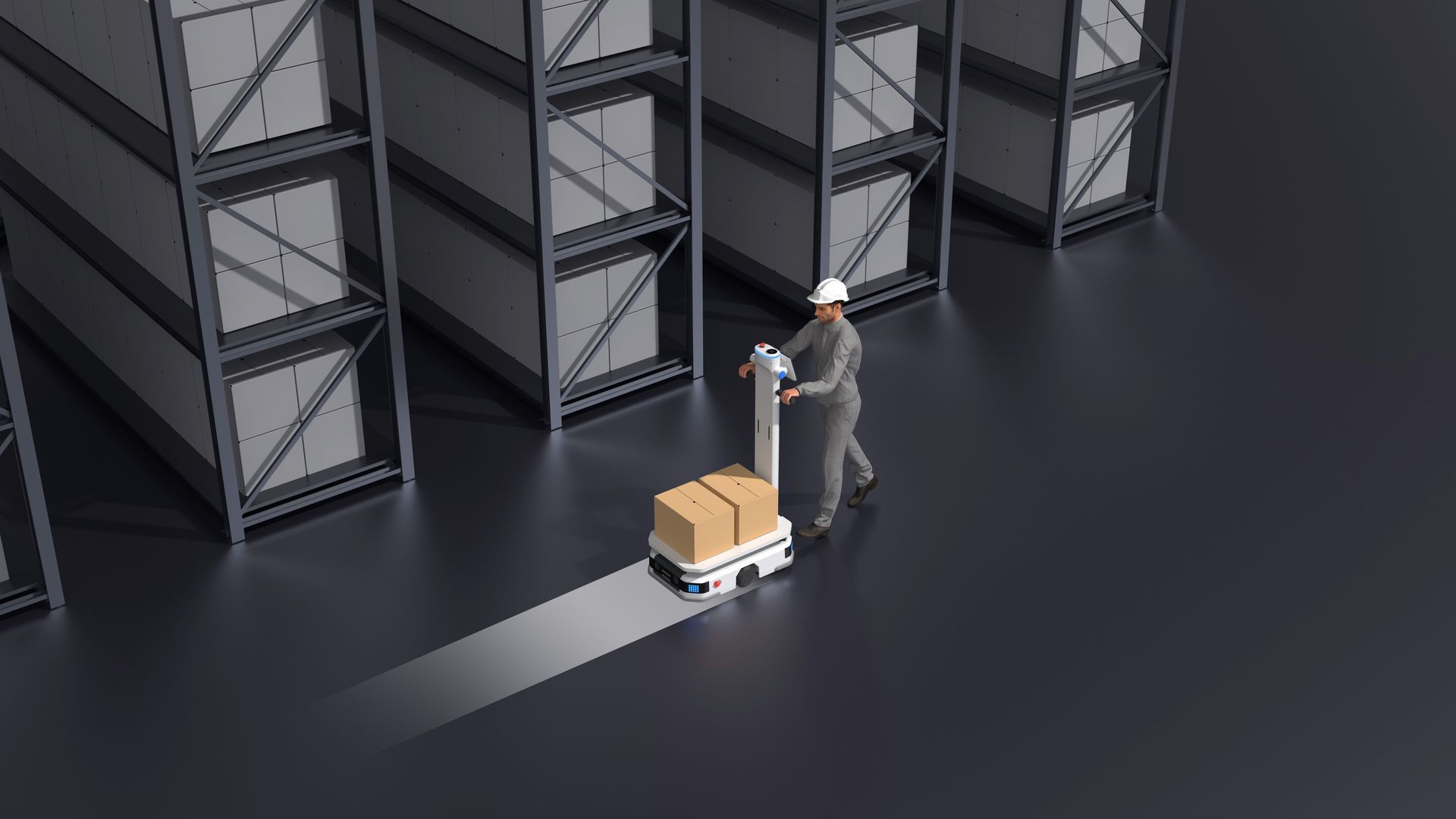 Person in hardhat pushing a robotic cart with a box in a warehouse aisle.