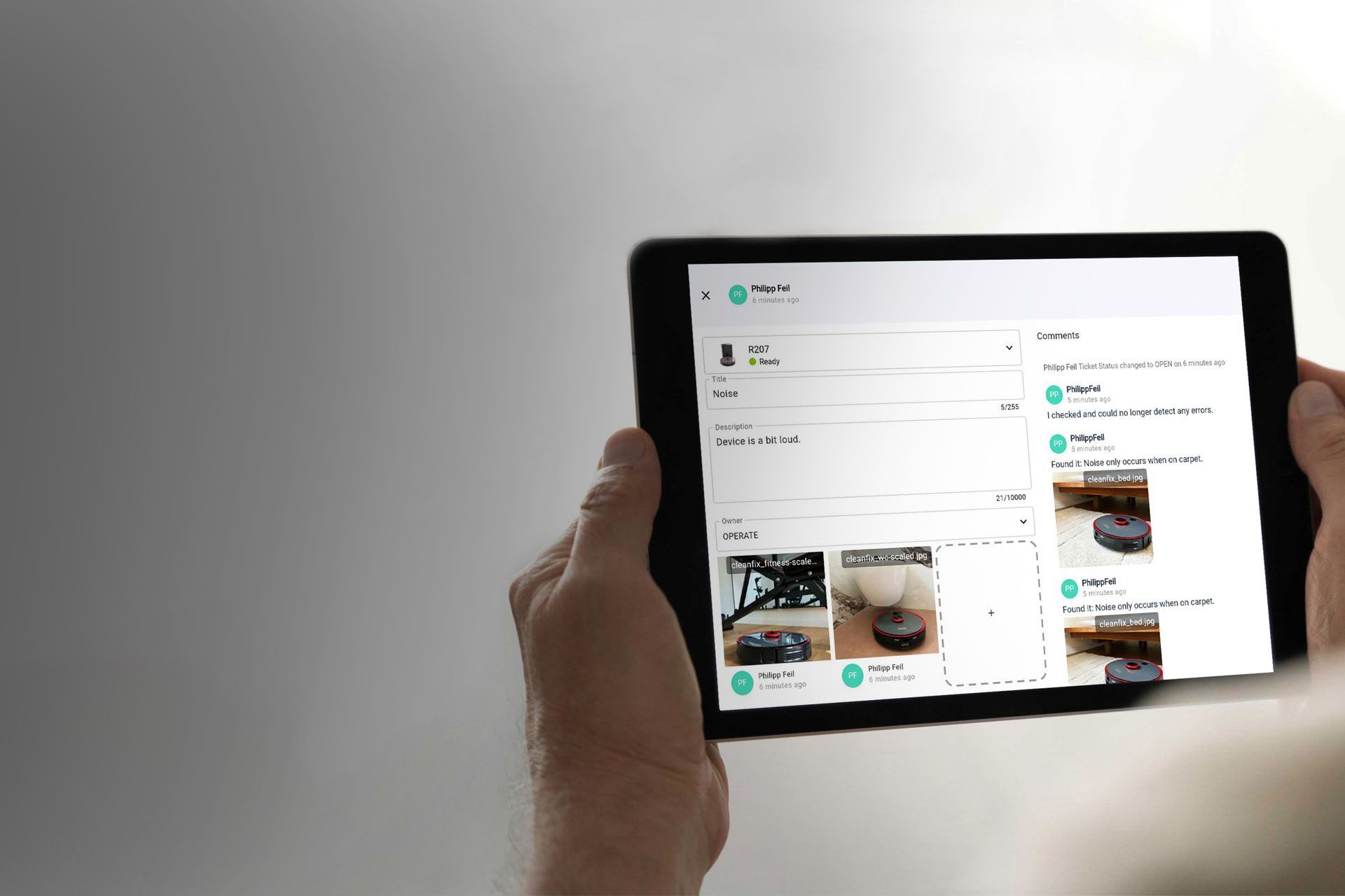 Person holding a tablet displaying an online shopping website; various product listings are visible.