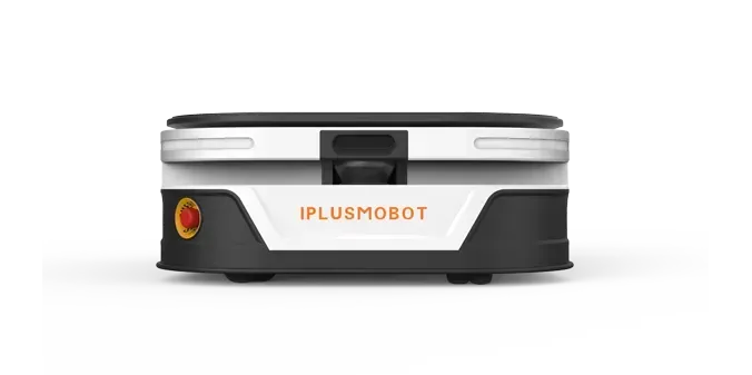 A person walks in a warehouse, robots on rails with blue light paths, near storage racks.