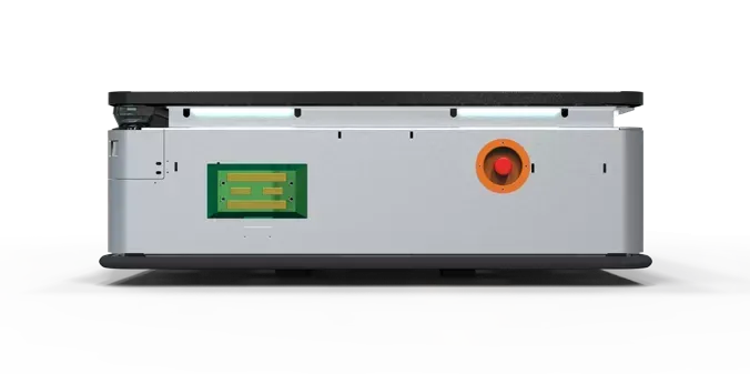 Person in hardhat pushing a robotic cart with a box in a warehouse aisle.