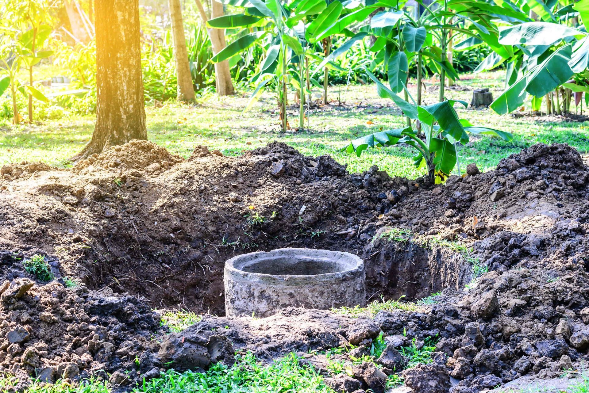A well is being built in the middle of a dirt field.