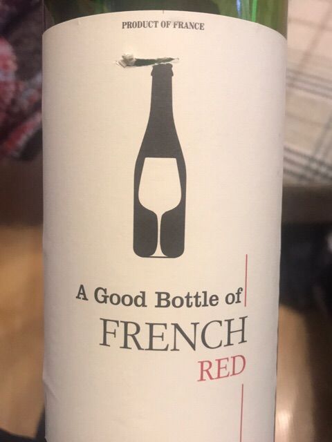 A bottle of french red has a picture of a bottle and a glass on the label