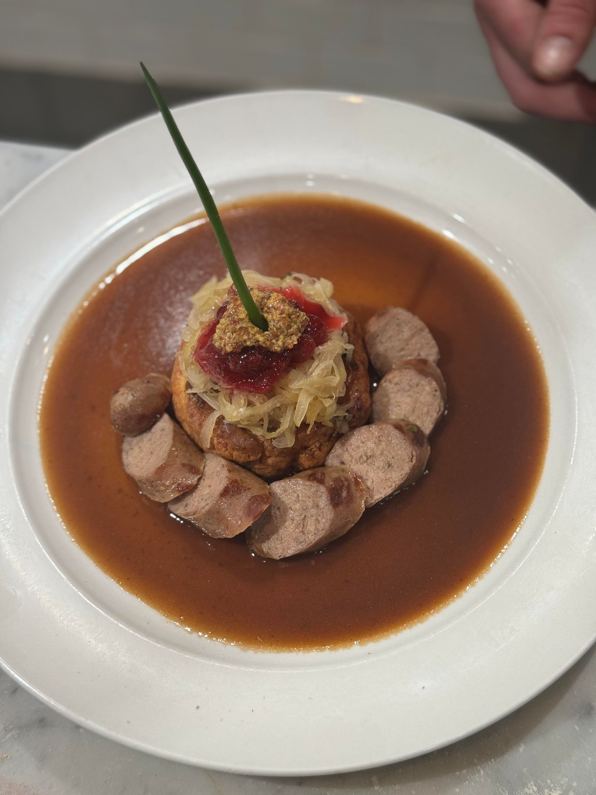 A plate of food with meat and sauce on a table