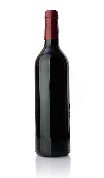 A bottle of red wine with a red cap on a white background.