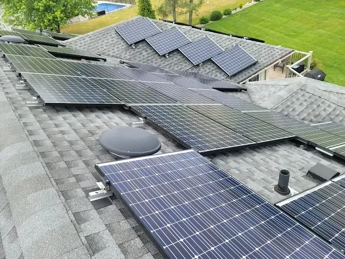 Solar panels installed on a gray asphalt shingle roof.