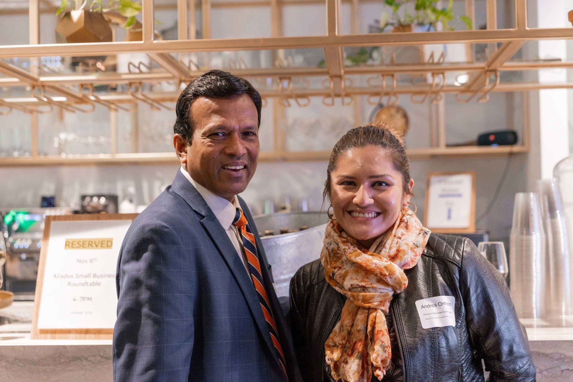 A man and a woman are posing for a picture in a restaurant.