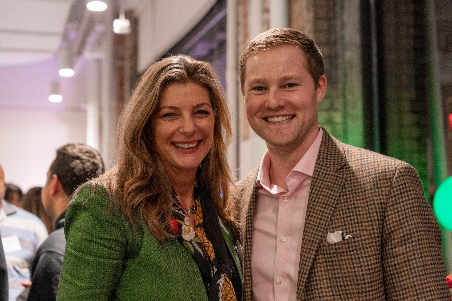 A man and a woman are posing for a picture at a party.