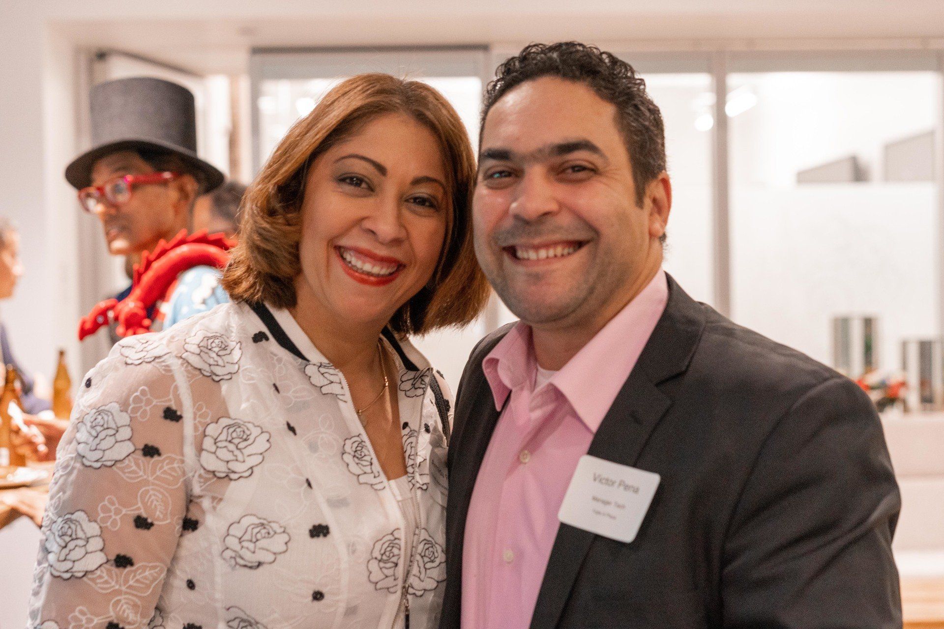 A man and a woman are posing for a picture together and smiling.