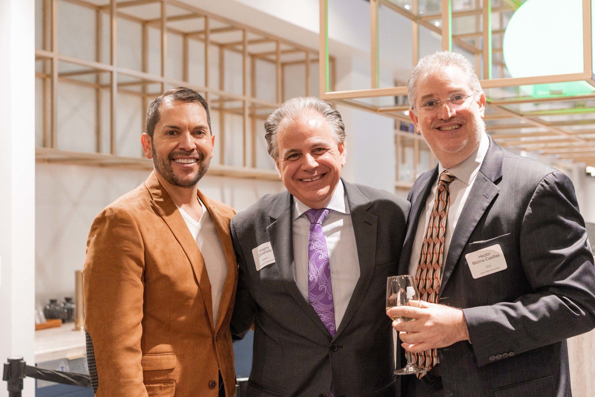 Three men in suits and ties are posing for a picture.